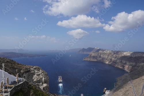 Fototapeta Naklejka Na Ścianę i Meble -  Aerial view of boats in clear blue bay surrounded by rocky cliffs in Greece