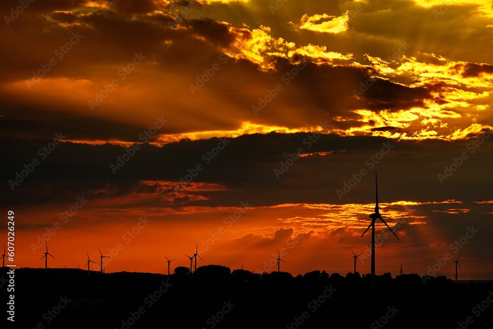 Scenic view of wind turbines in a field during a mesmerizing cinematic sunset