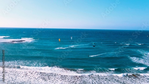 Photography A group of people kite surfing at Alagadi Beach in Kyrenia, North Cyprus on sunn