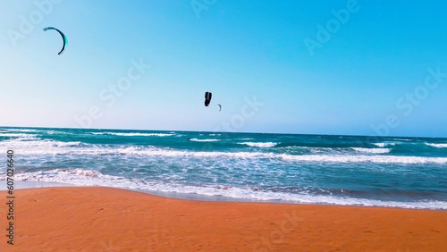 Photography A group of people kite surfing at Alagadi Beach in Kyrenia, North Cyprus on sunn