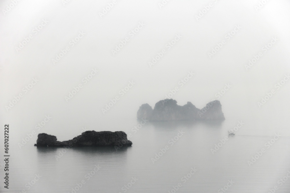 Landscape view of the rocks of Halong Bay, Vietnam on a foggy day