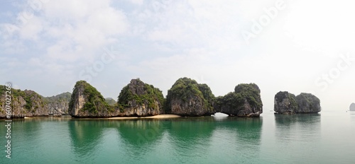 Panoramic shot of the rocks reflected in the water in Halong Bay, Vietnam