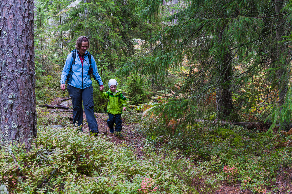 Mother and son enjoying a forest trail Mother and son enjoying a forest trail
