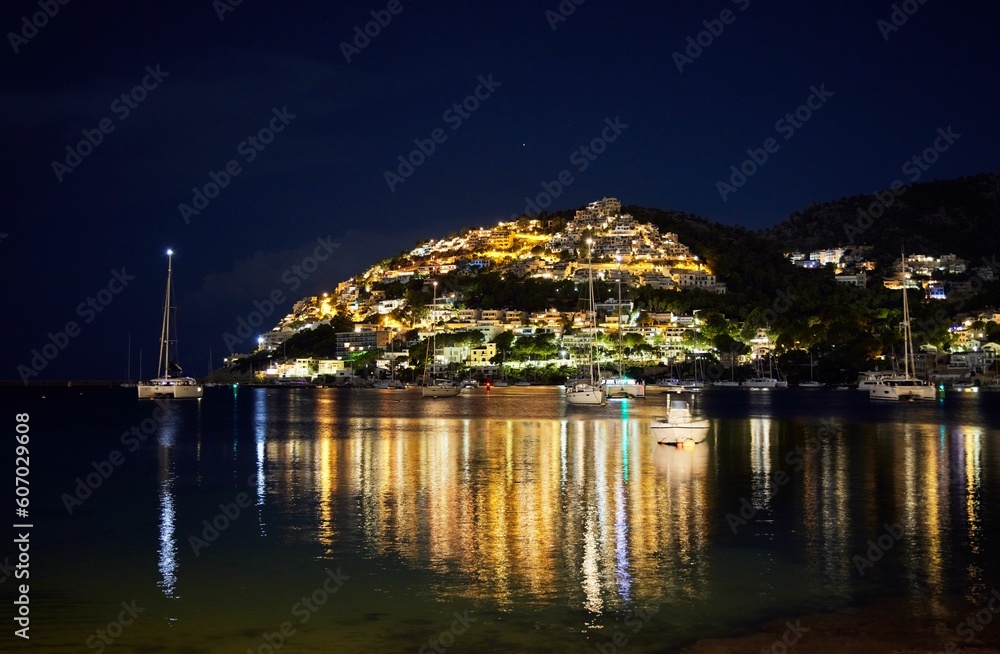 Night scene of illuminating Port Andratx on the island reflecting on water in Mallorca, Spain