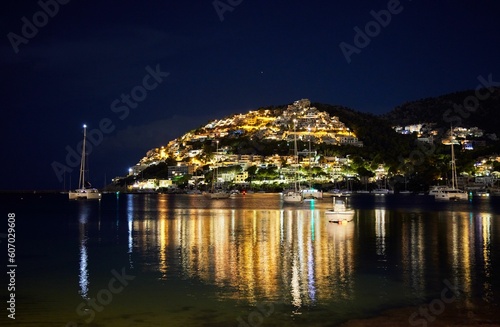 Night scene of illuminating Port Andratx on the island reflecting on water in Mallorca  Spain