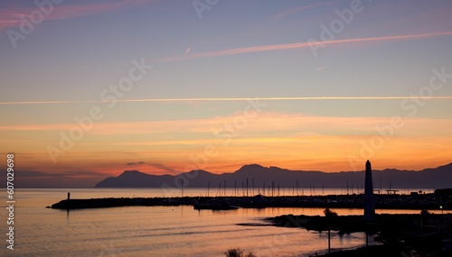 Aerial view of sea with port during sunset