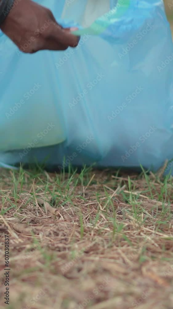 Rubbish spread on the ground picked up by people Rubbish spread on the ground picked up by people