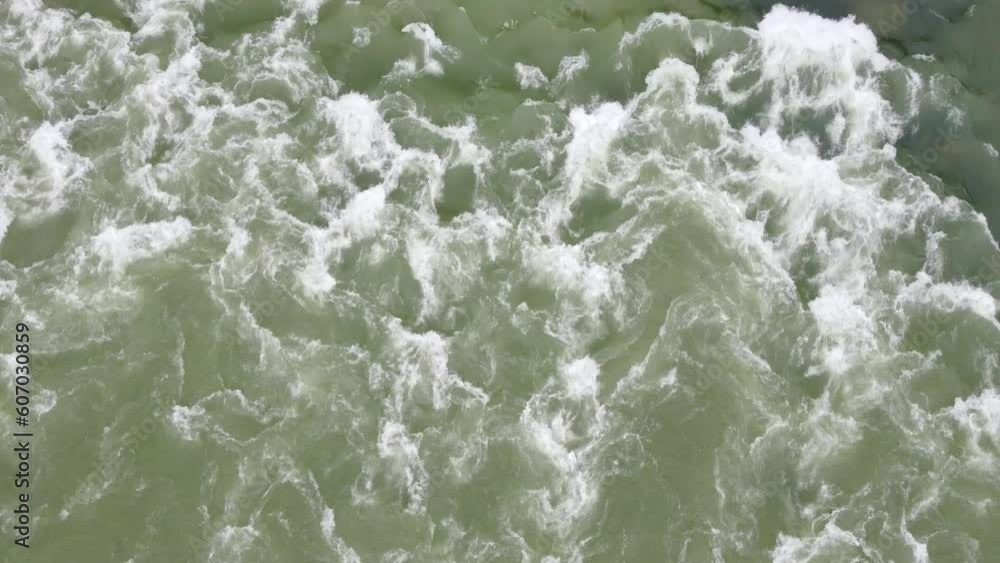 Muddy rive flowing after heavy rain. Floods in spring. River cascade in nature. Muddy rive flowing after heavy rain. Floods in spring. River cascade in nature.
