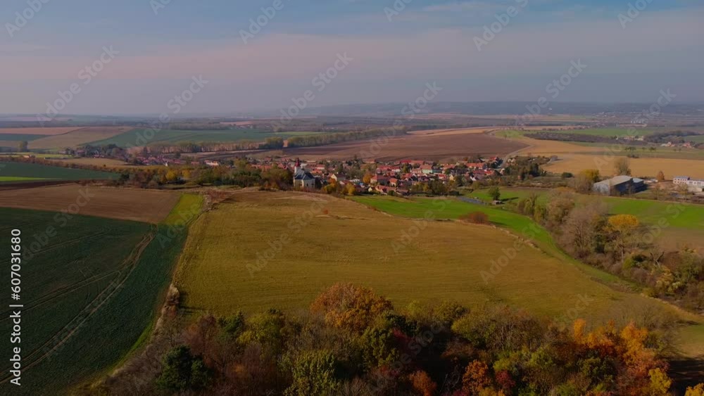 Aerial of a small village surrounded by the fields during a sunny autumn day Aerial of a small village surrounded by the fields during a sunny autumn day