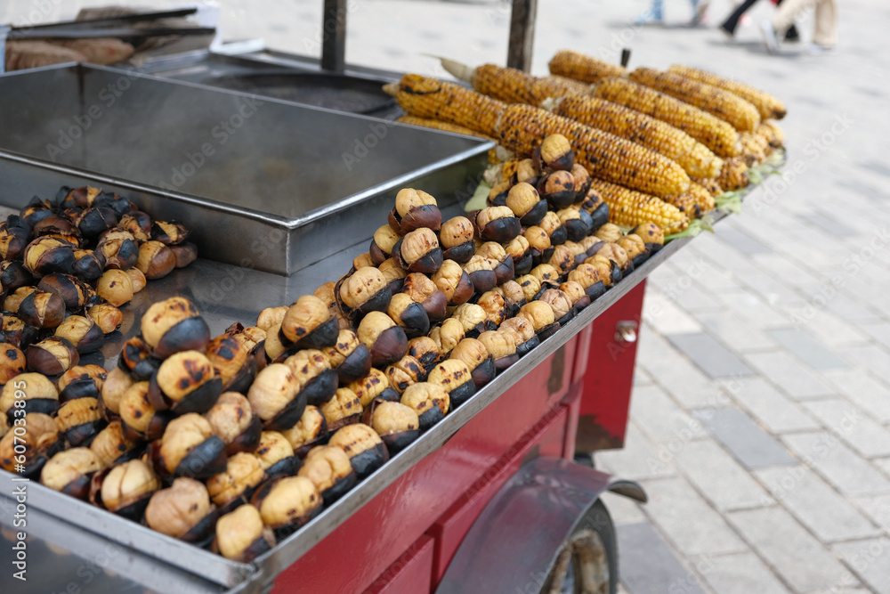 Roasted chestnuts and grilled corn ready for sale. Street food on a cart. Close-up. selective focus. Traditional fast food in Turkey.
