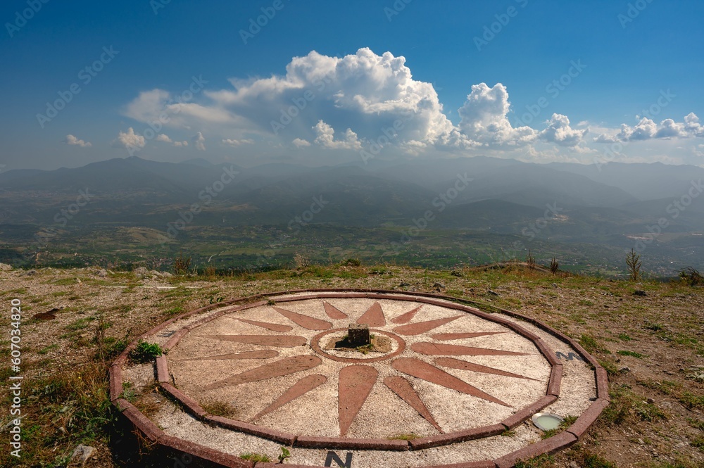 Compass on the viewpoint of Vodno hill with beautiful mountains in the background in Skopje