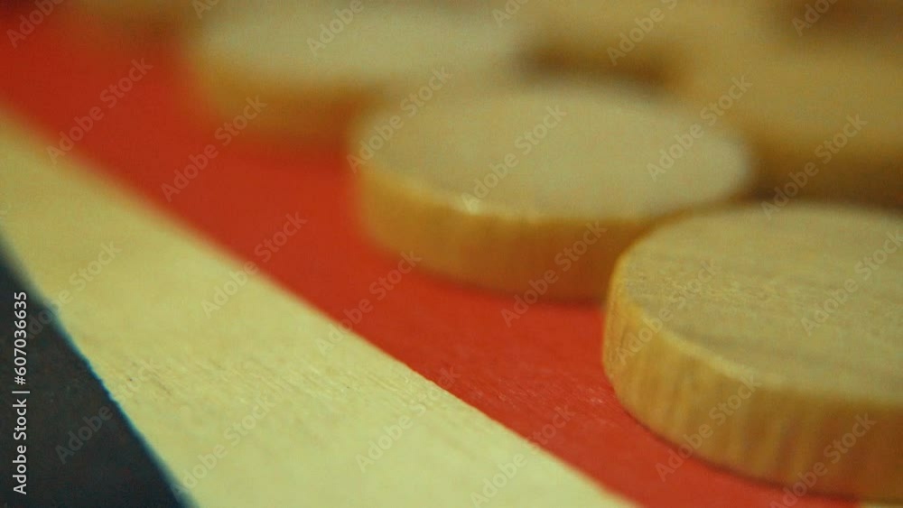 Macro cinematic sliding shot of a backgammon wooden board game, brown chips, Slow motion, Full HD Macro cinematic sliding shot of a backgammon wooden board game, brown chips, Slow motion, Full HD