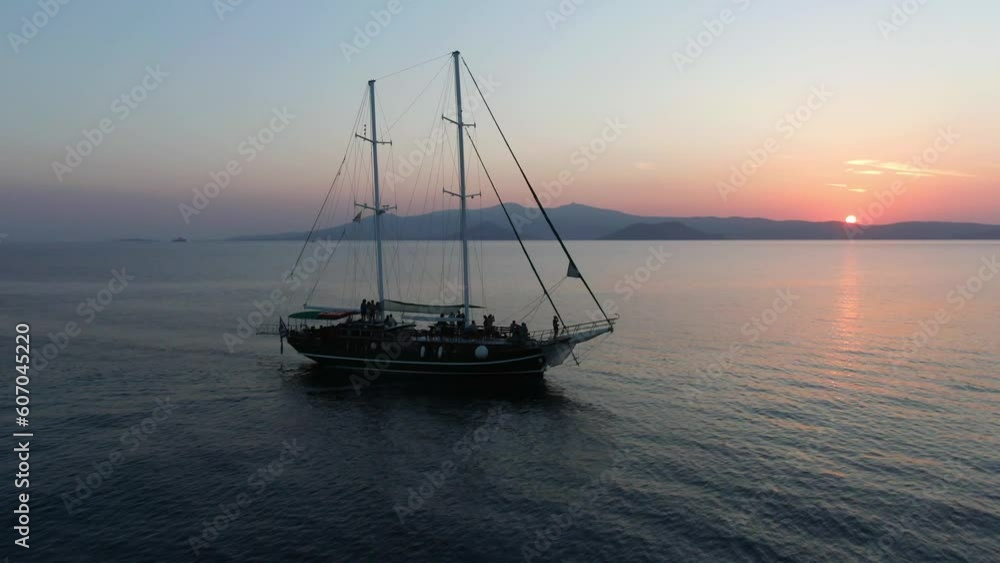 Aerial drone rising shot of old boat in ocean in the sunset Aerial drone rising shot of old boat in ocean in the sunset