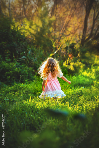 Little girl playing in the woods