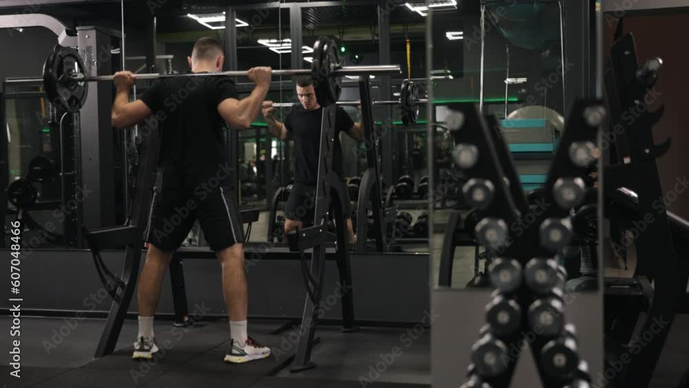 Healthy lifestyle, Squat technique, Workout plans. Bodybuilder partakes in rigorous barbell squat workouts with weights on his neck, radiating potent masculine force and endorsing health-conscious Healthy lifestyle, Squat technique, Workout plans. Bodybuilder partakes in rigorous barbell squat workouts with weights on his neck, radiating potent masculine force and endorsing health-conscious