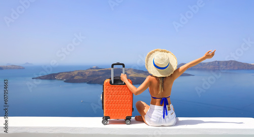 Happy moment with young woman tourist as orange the luggage in Santorini island,Greece