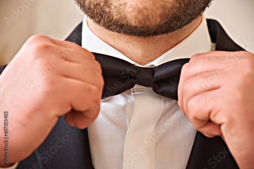 Photography Groom's hands fix his tie. Holiday. Close-up.
