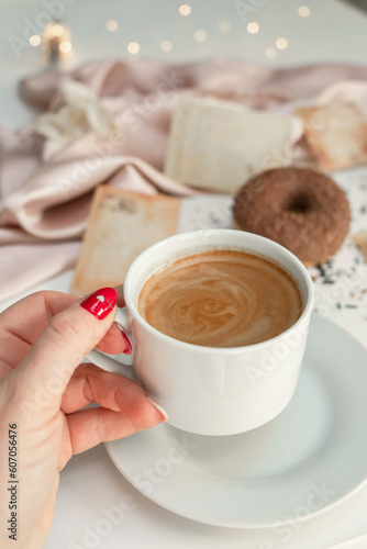 Wallpaper Mural Close-up of a cup of coffee held by a woman's hand. Torontodigital.ca