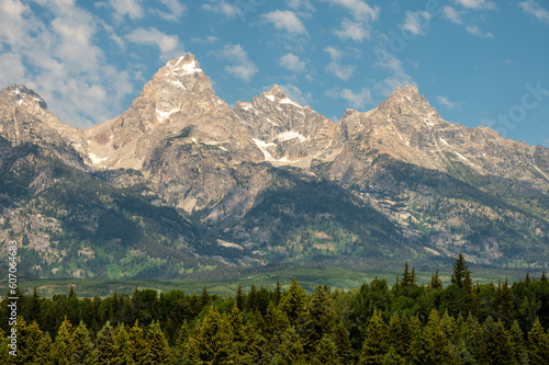 Grand Teton Rises High Over The Trees In The Valley Below