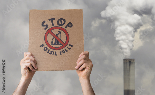 Stop fossil fuels poster on an smoking chimney background. CO2 emissions, battle for climate change