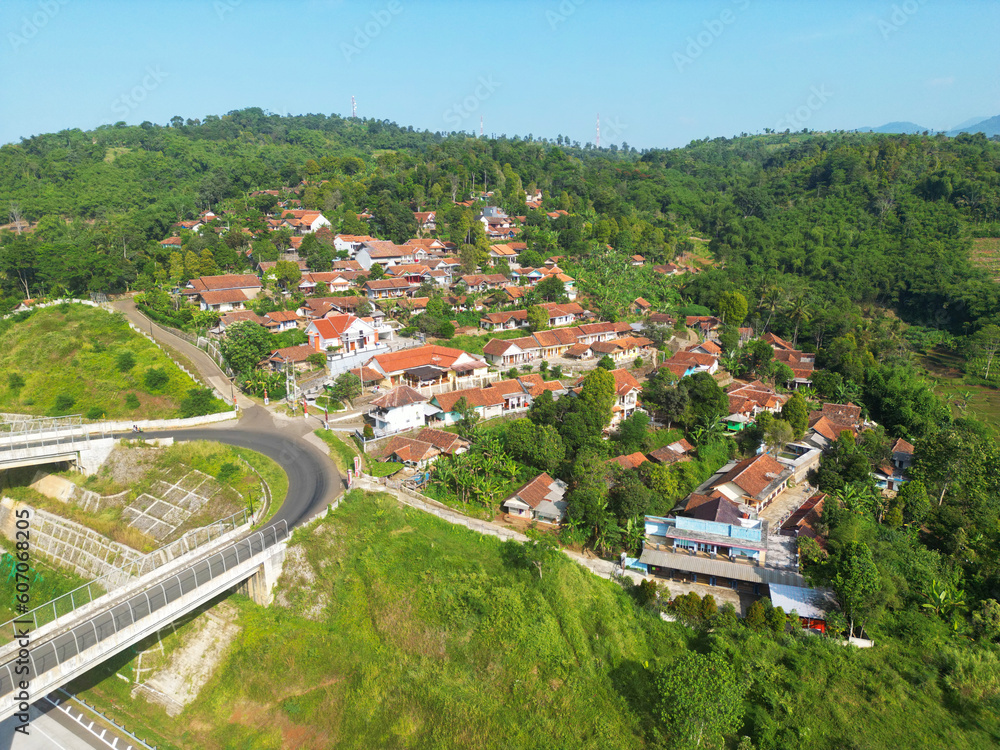 Aerial view of slope houses near the flyover on the Cisumdawu toll road in Sumedang Regency, West Java, Indonesia