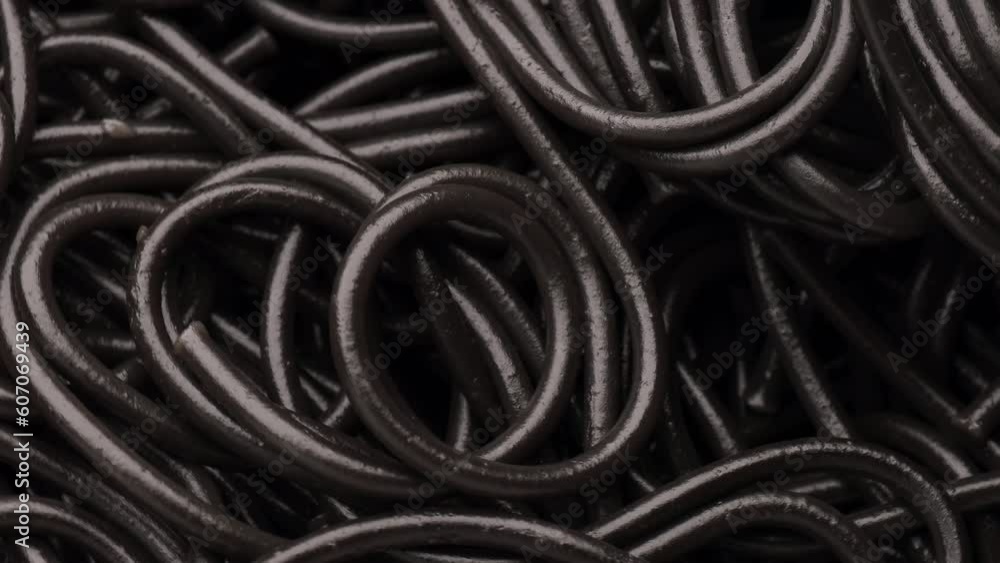 Black boiled pasta, rotation in circle. cooked cuttlefish ink black pasta Turning. selective focus Black boiled pasta, rotation in circle. cooked cuttlefish ink black pasta Turning. selective focus