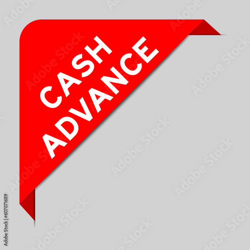 Red color of corner label banner with word cash advance on gray background