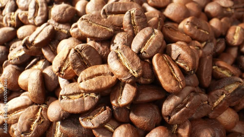 The macro video of many coffee beans on the floor offers a visually stunning exploration of the rich colors, textures, and aromas present in each individual bean. Brown background video footage. 4K
The macro video of many coffee beans on the floor offers a visually stunning exploration of the rich colors, textures, and aromas present in each individual bean. Brown background video footage. 4K