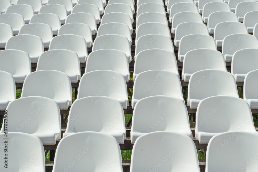 Naklejka premium Seats of tribune on sport stadium. Concept of fans, chairs for audience, cultural environment concept. mpty seats, modern stadium.