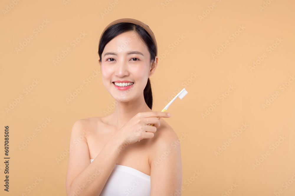 portrait beauty young woman with healthy happy smile holding toothbrush in her hand at morning isolated on beige studio background. hygiene tooth mouth clean care and dental concept. portrait beauty young woman with healthy happy smile holding toothbrush in her hand at morning isolated on beige studio background. hygiene tooth mouth clean care and dental concept.