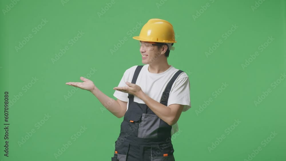 Asian Man Worker Wearing Goggles And Safety Helmet Smiling And Pointing To Side While Standing In The Green Screen Background Studio
Asian Man Worker Wearing Goggles And Safety Helmet Smiling And Pointing To Side While Standing In The Green Screen Background Studio