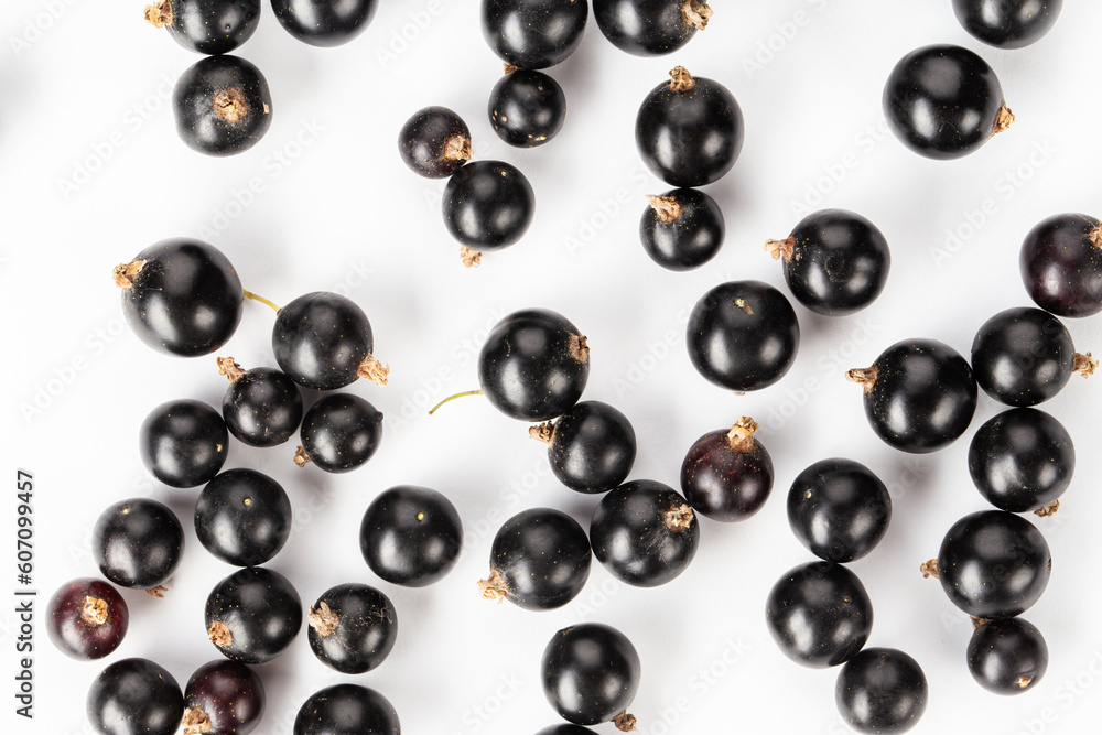 Ripe blackcurrant berries are scattered, top view. Isolated on a white background. Ripe blackcurrant berries are scattered, top view. Isolated on a white background.