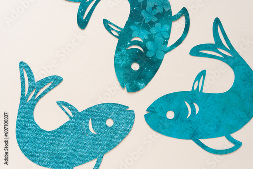machine-cut generic fish-shapes on blank art paper