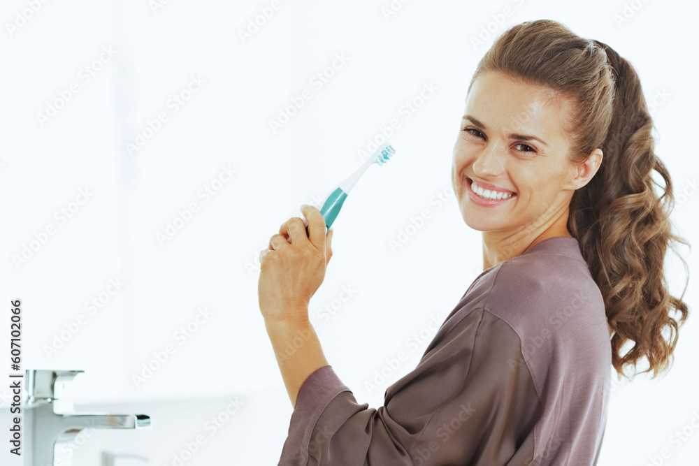 smiling woman with toothbrush in bathroom smiling woman with toothbrush in bathroom