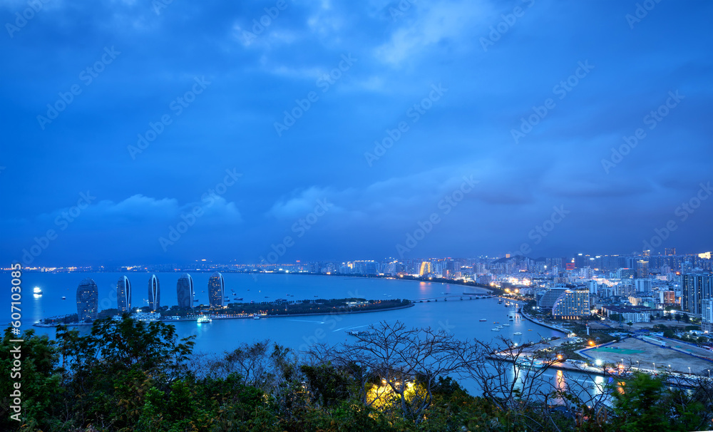 Bird's-eye view of the coastal city, Sanya, Hainan, China at night.