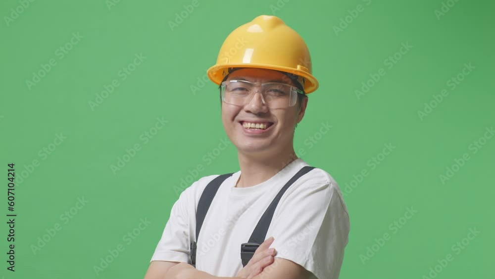 Close Up Of Side View Of Asian Man Worker Wearing Goggles And Safety Helmet Smiling And Crossing His Arms While Standing In The Green Screen Background Studio
Close Up Of Side View Of Asian Man Worker Wearing Goggles And Safety Helmet Smiling And Crossing His Arms While Standing In The Green Screen Background Studio