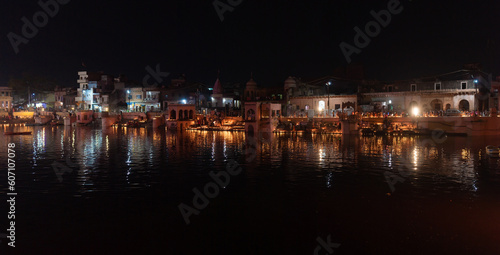 general night view, sacred place on govardhan hill in india, place of pilgrimage, shrine of believers, manasi ganga lake, people light fire lamps