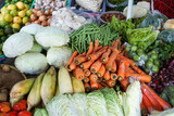 Stack of various types of fresh vegetables at the market table