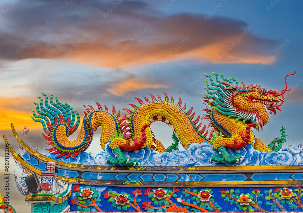 Obraz premium Colourful multicoloured dragon on top of a temple in Patong Phuket Thailand. beautiful blue green red of the scale dragons