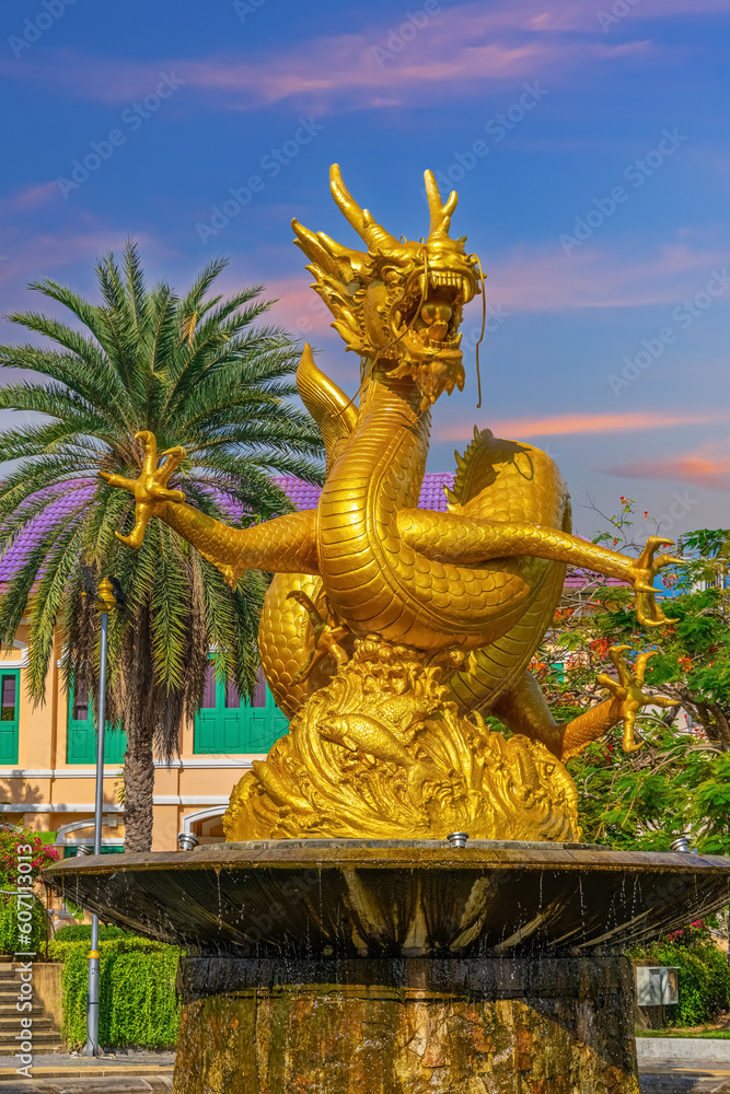 Fototapeta premium Golden dragon in old phuket town phuket Thailand this dragon is on the middle of a big water pond and fountain Chinese Dragon