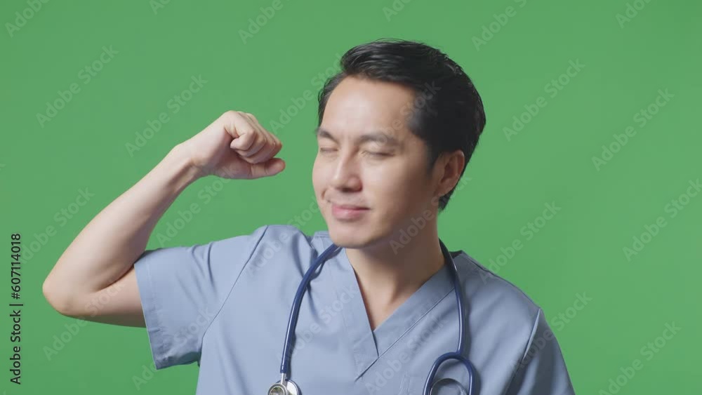 Close Up Of Asian Male Doctor With Stethoscope Smile And Flex Muscle On Green Screen Background In The Hospital
Close Up Of Asian Male Doctor With Stethoscope Smile And Flex Muscle On Green Screen Background In The Hospital