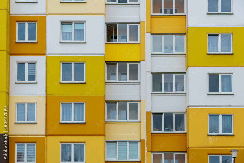 Modern residential multi-storey building. Windows and balconies on a new residential building close-up. Buying and selling apartments, rental housing, happy family life in a comfortable apartment.