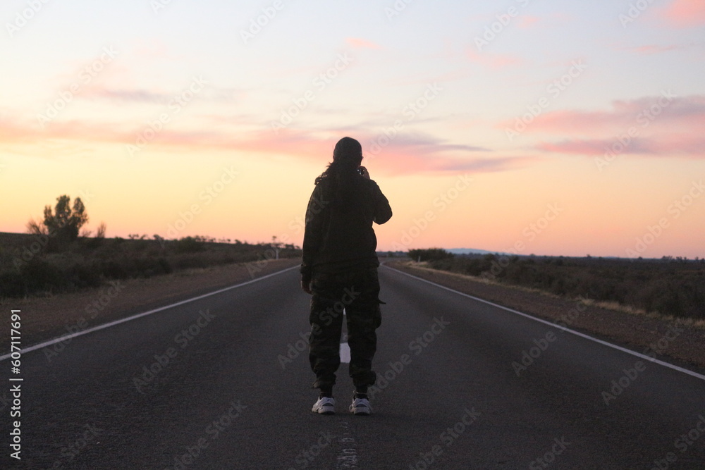 silhouette of a person on the road