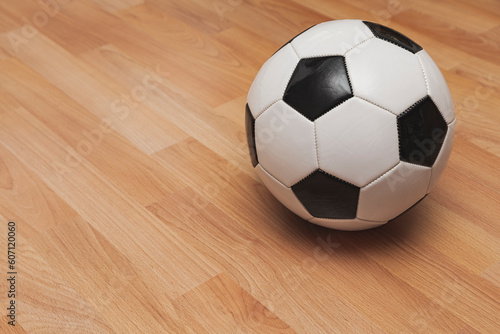 A soccer ball over a wooden floor