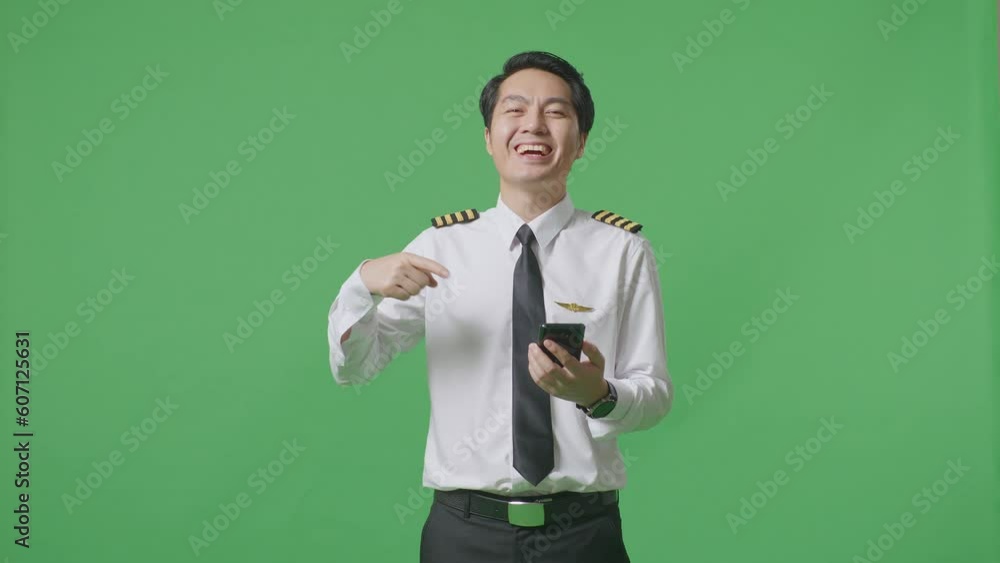 Asian Man Pilot Smiling And Pointing To Smartphone In His Hand While Standing In The Green Screen Background Studio
Asian Man Pilot Smiling And Pointing To Smartphone In His Hand While Standing In The Green Screen Background Studio