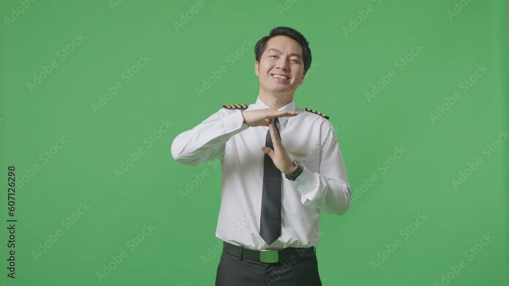 Asian Man Pilot Looking At Camera And Showing Time Out Hands Gesture While Standing In The Green Screen Background Studio
Asian Man Pilot Looking At Camera And Showing Time Out Hands Gesture While Standing In The Green Screen Background Studio