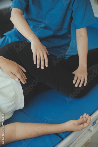 Physiotherapist working with patient in clinic, closeup © Sirikarn Rinruesee