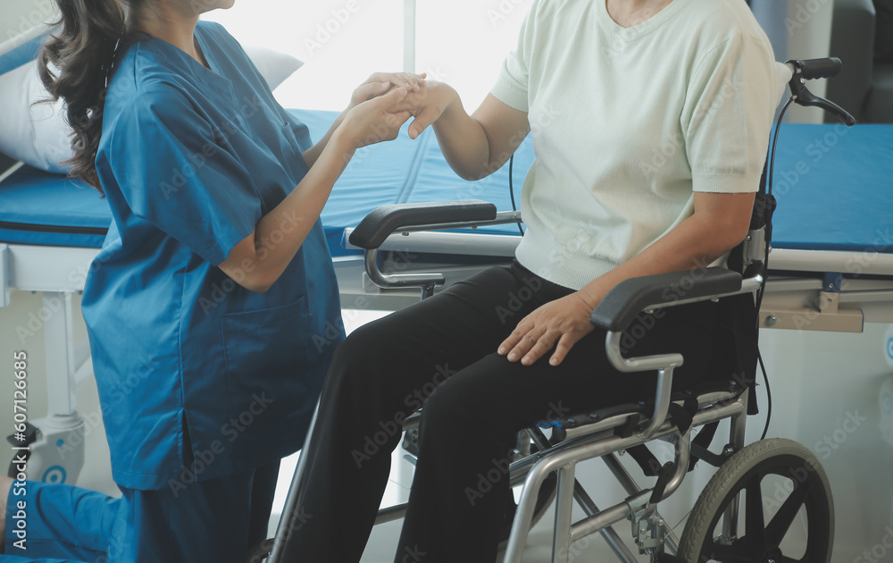 Doctor or nurse or physiotherapist caregiver exercise with senior woman at clinic or nursing home Doctor or nurse or physiotherapist caregiver exercise with senior woman at clinic or nursing home