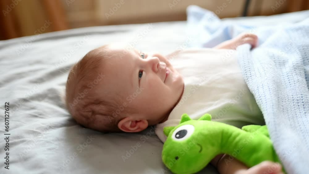 Cute baby lies in the crib sleeps at home with his favorite toy.Childhood protection concept, children day, sleep toy Cute baby lies in the crib sleeps at home with his favorite toy.Childhood protection concept, children day, sleep toy