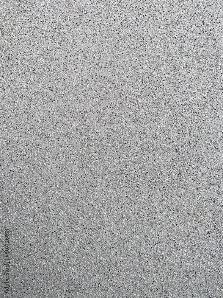 Textured plaster, white with black in the form of small stones, used as a background, side view, texture Textured plaster, white with black in the form of small stones, used as a background, side view, texture